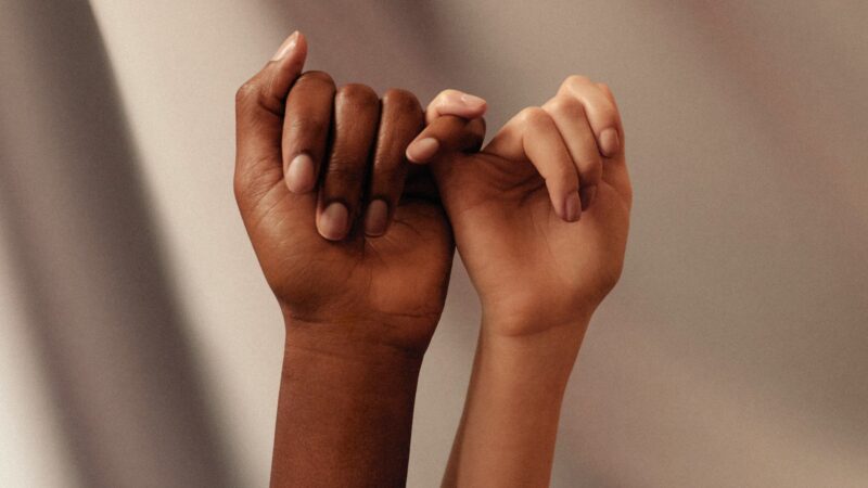 persons hand with white manicure