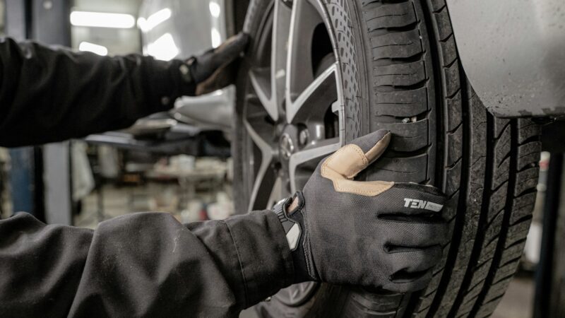 a man working on a tire in a garage