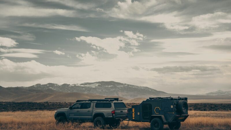 black suv on brown field under white clouds during daytime