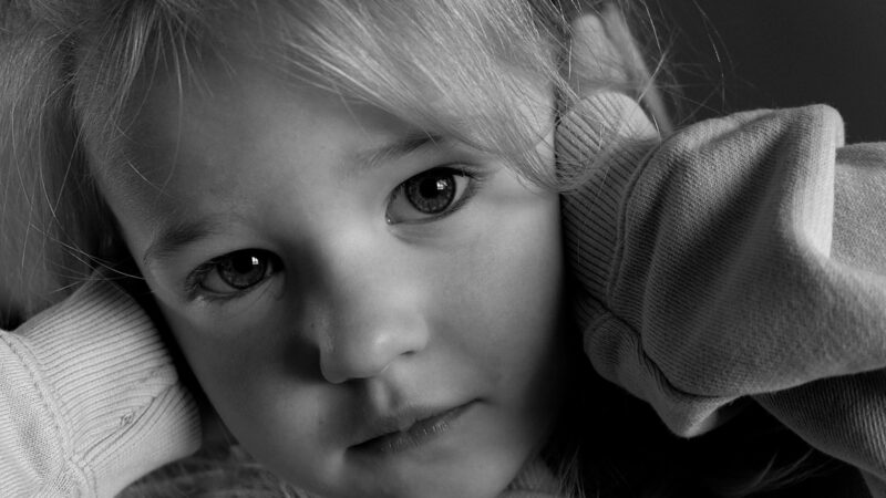 a black and white photo of a little girl